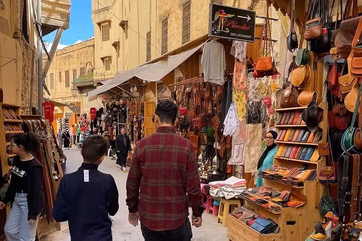 Stroll through bustling markets with colorful leather goods on a guided tour in Fez's Old Medina.