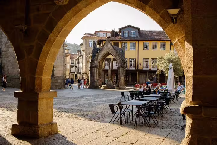 Explore the historic charm of Guimarães with its picturesque arches and vibrant cafes on a half-day tour from Porto.