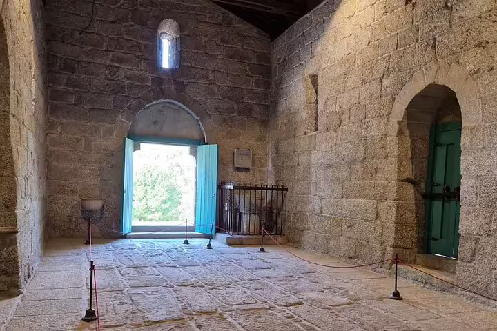 Interior of a historic stone building in Guimarães, showcasing the medieval architecture on the private tour from Porto.