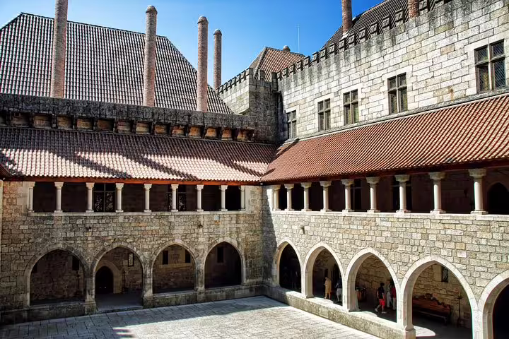Explore the medieval architecture of Guimarães Palace courtyard on a full-day tour with lunch in Braga.