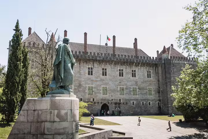 Statue and medieval architecture at the Palace of the Dukes of Braganza in Guimarães, a highlight of private tours from Porto.