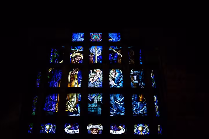 Vibrant stained glass window art in a historic Guimarães site, a highlight of the private half-day tour in Portugal.