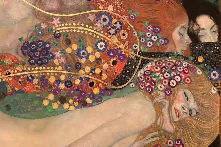 Close-up of Gustav Klimt's intricate artwork featuring vibrant flowers and figures, showcased in Vienna's art tour.