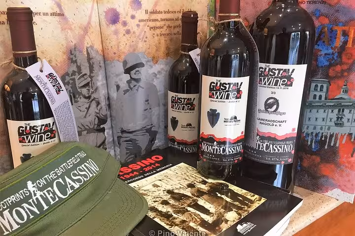 Bottles of Gustav Wine alongside Monte Cassino memorabilia, highlighting the blend of history and culture.
