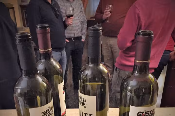 Bottles of Gustav Wine are showcased as guests enjoy a wine tasting session during the Monte Cassino history tour.