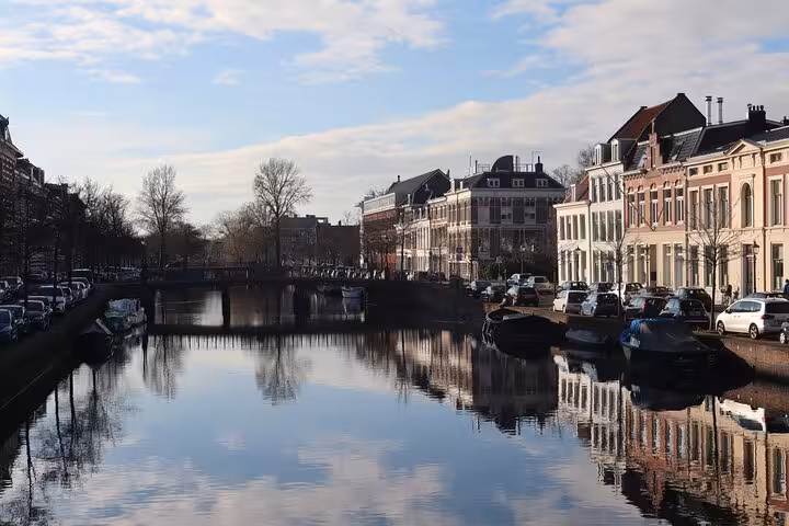 Haarlem canal view with historic houses and reflections, featured on 2-hour walking tour of city highlights