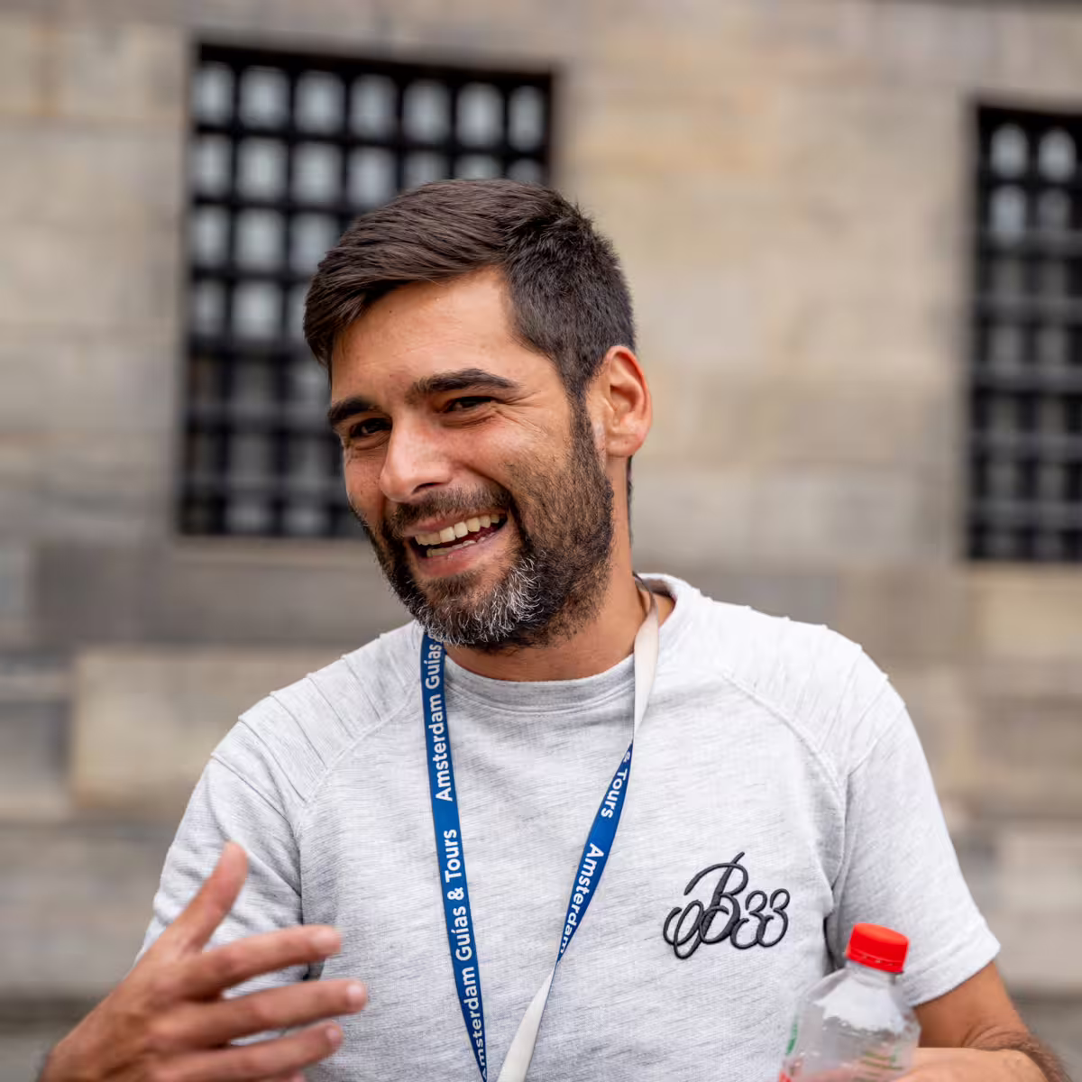 Friendly tour guide in Haarlem, Netherlands, smiling during a walking tour from Amsterdam, showcasing local expertise and charm.