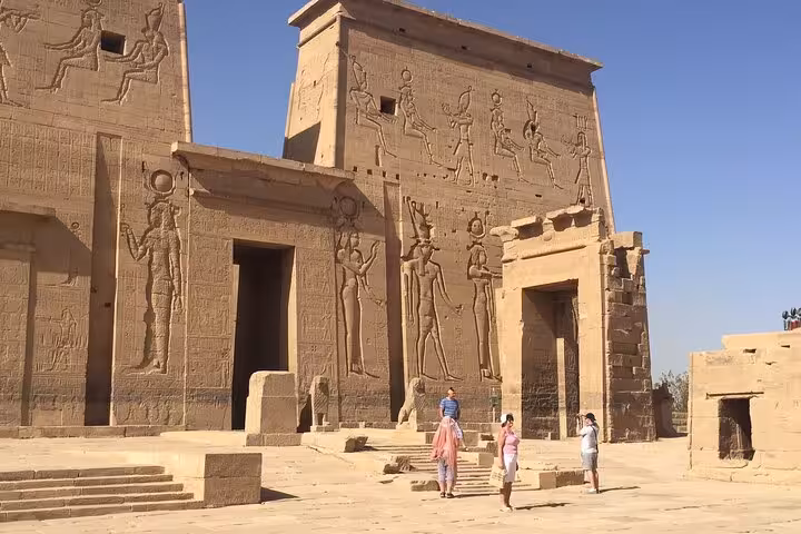 Philae Temple facade with ancient carvings on Luxor day trip from Hurghada, Habu City Ramses III tour