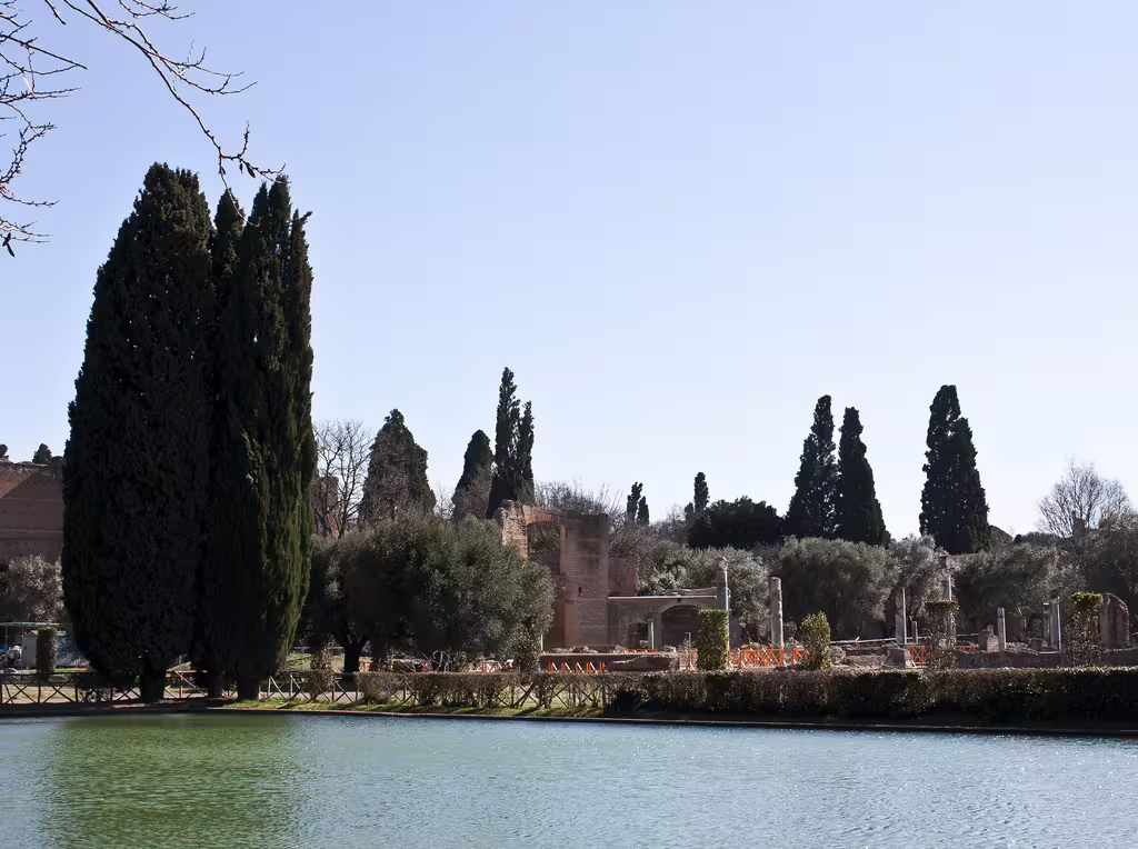 Scenic view of Hadrian's Villa ruins and cypress trees reflected in a tranquil pool during a small-group Tivoli tour from Rome