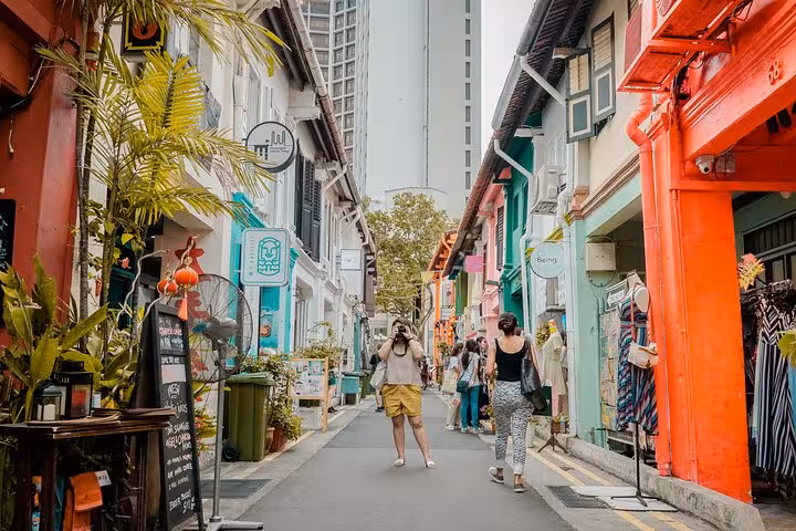 Vibrant Haji Lane in Singapore, showcasing colorful shophouses and tourists, ideal for the Instagram Walking Tour with free eSIM.
