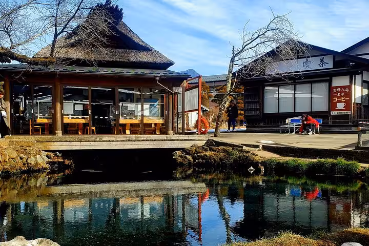 Traditional Japanese architecture by a serene pond, offering a glimpse into Hakone's cultural charm.