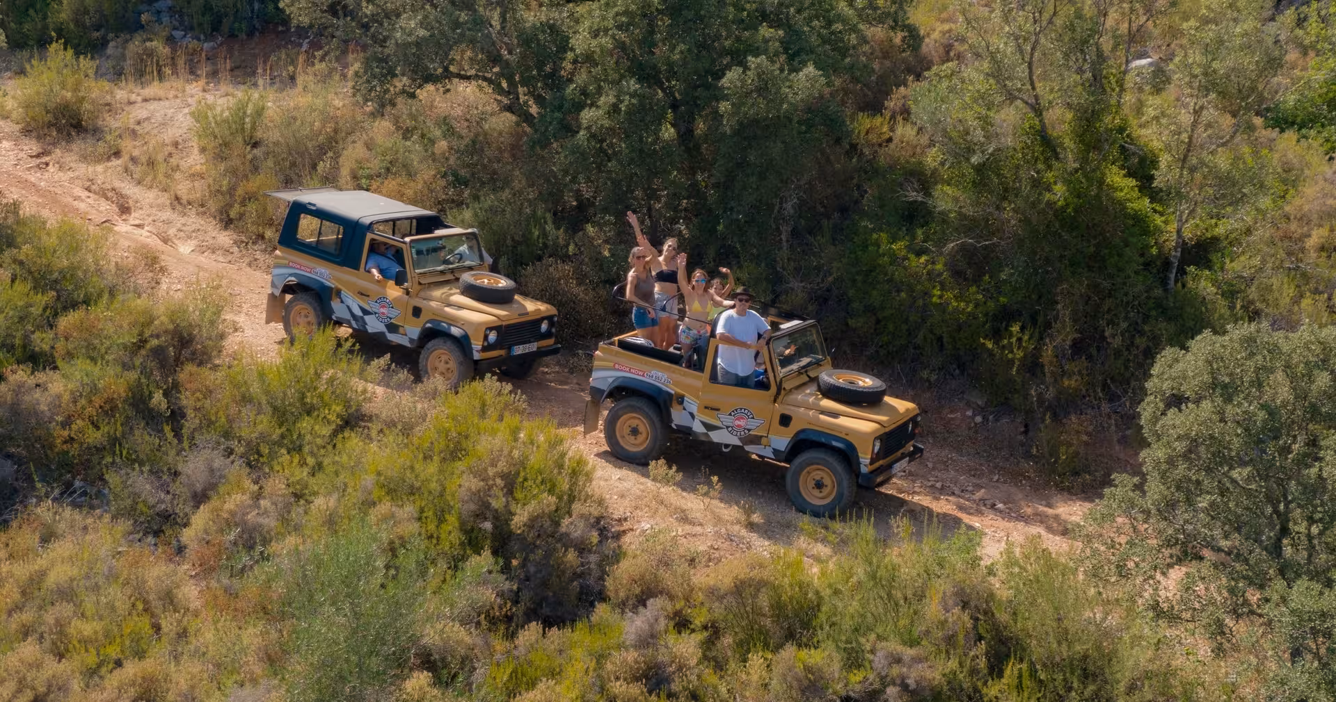 Open-top jeeps with excited friends on a rugged dirt track during a guided half-day private safari adventure