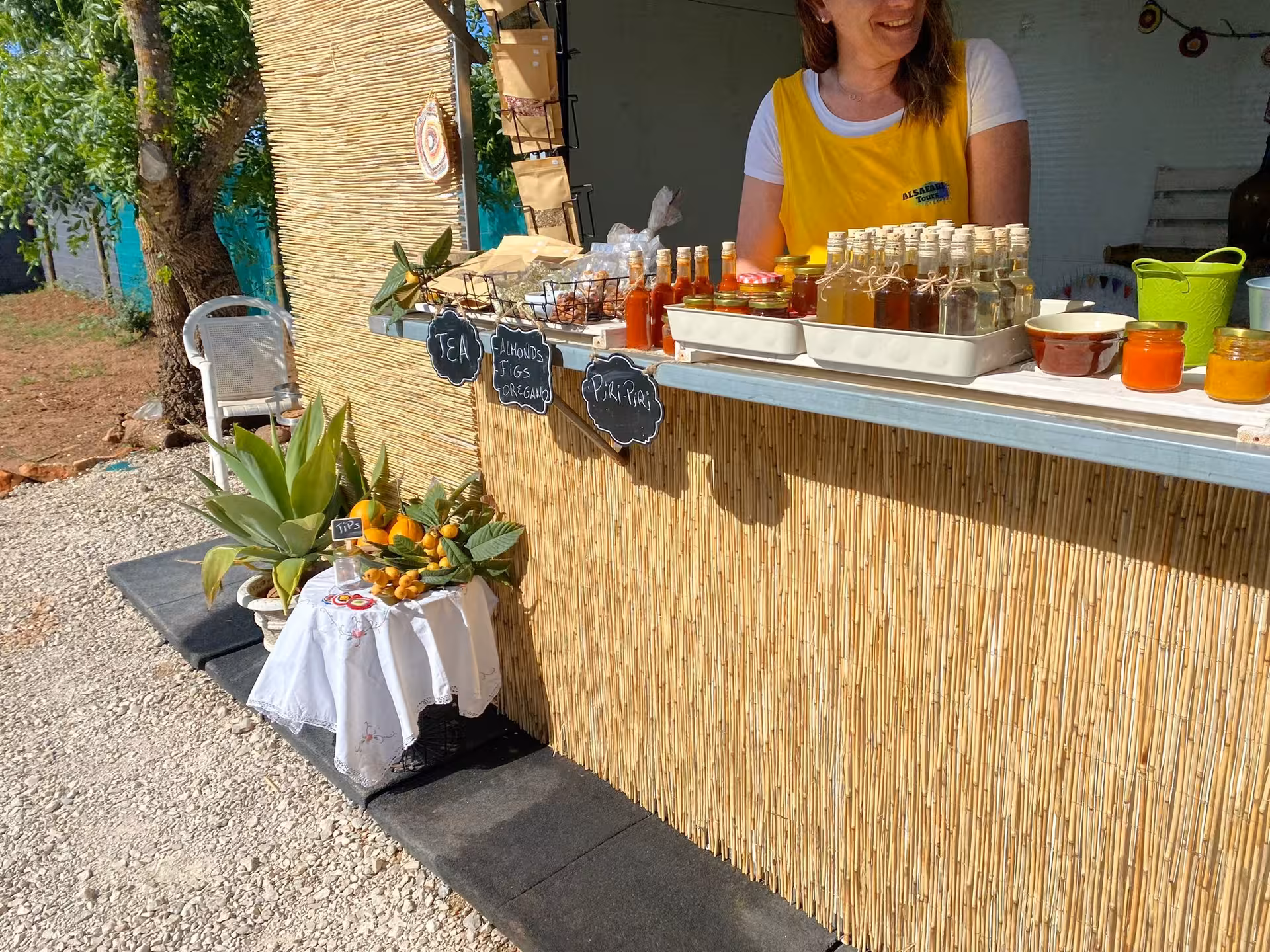 Local farm stand on half day wine tour with homemade liqueurs, jams and fresh citrus fruits displayed in the countryside