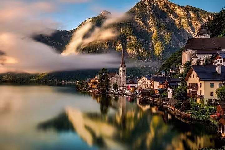 Hallstatt lakeside village with church spire and alpine reflections, Salzburg private day tour to Bad Ischl