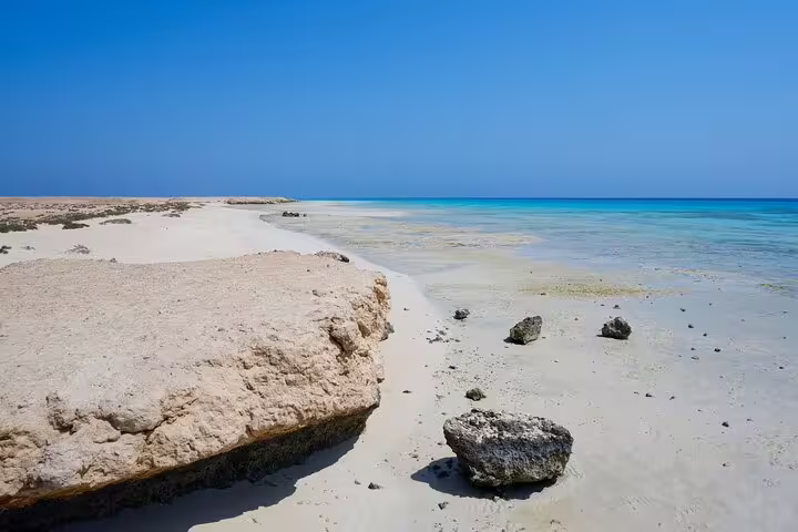 White sand shoreline and shallow turquoise lagoon at Hamata Island, Marsa Alam VIP boat snorkeling day tour
