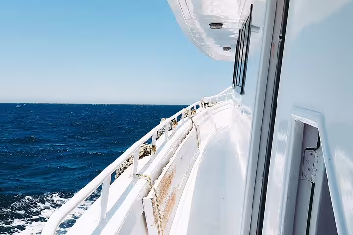 Boat deck cruising the Red Sea toward Hamata Islands, Marsa Alam snorkeling tour with island-hopping views