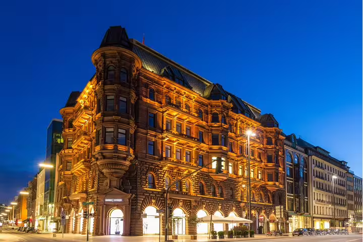 Illuminated historic Kontorhaus building in Hamburg at night, landmark on a self-guided scavenger hunt tour