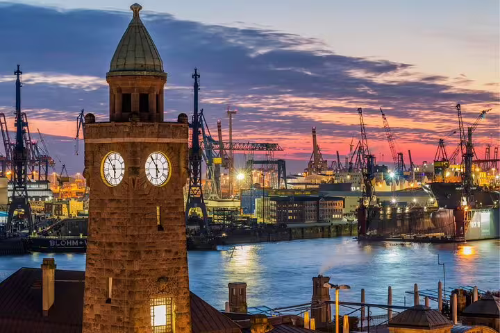 St. Pauli Elbe tunnel clock tower at sunset over Hamburg Harbor, ideal for a self-guided scavenger hunt tour