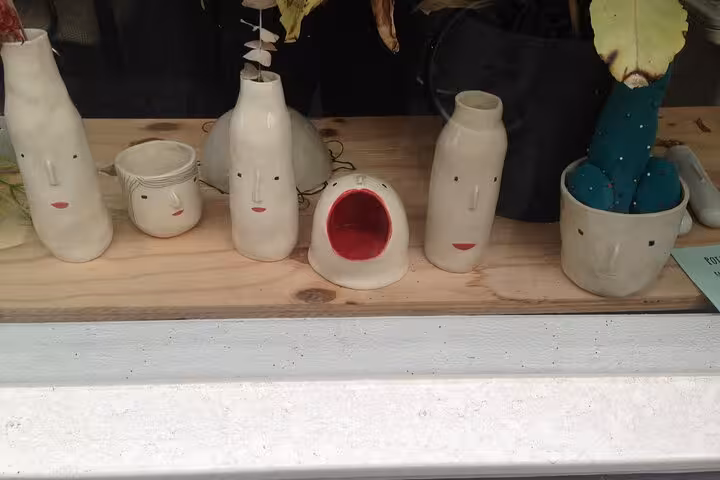 Handmade face pottery vases in a Rotterdam boutique, a quirky stop on a private sightseeing tour in Holland