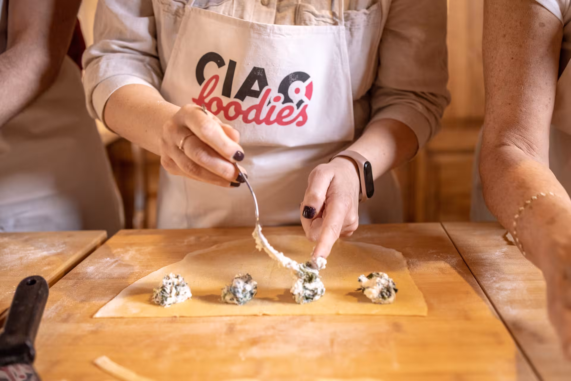 Hands skillfully crafting ravioli with ricotta filling during Pasta Lovers Cooking Class, featuring authentic Italian techniques.