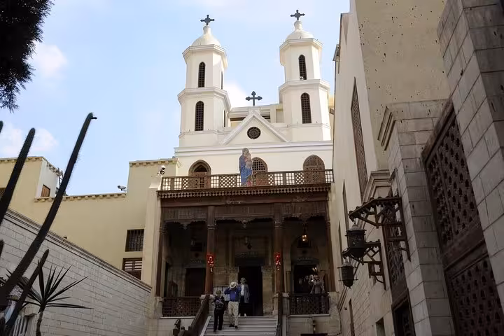 Front view of the Hanging Church in Coptic Cairo with twin bell towers, featured on Muizz Street and bazaar day tour