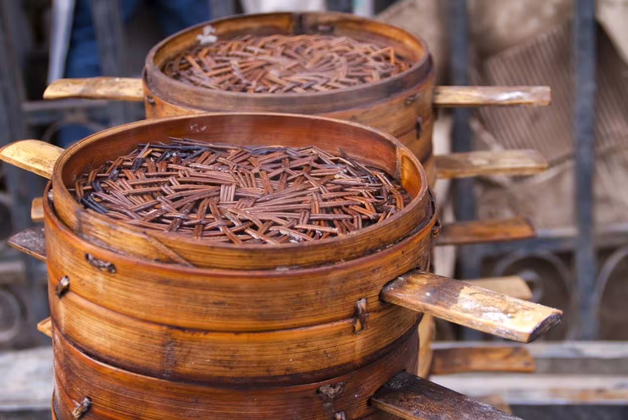 Traditional bamboo steamers used for cooking local delicacies in Hangzhou's street markets.