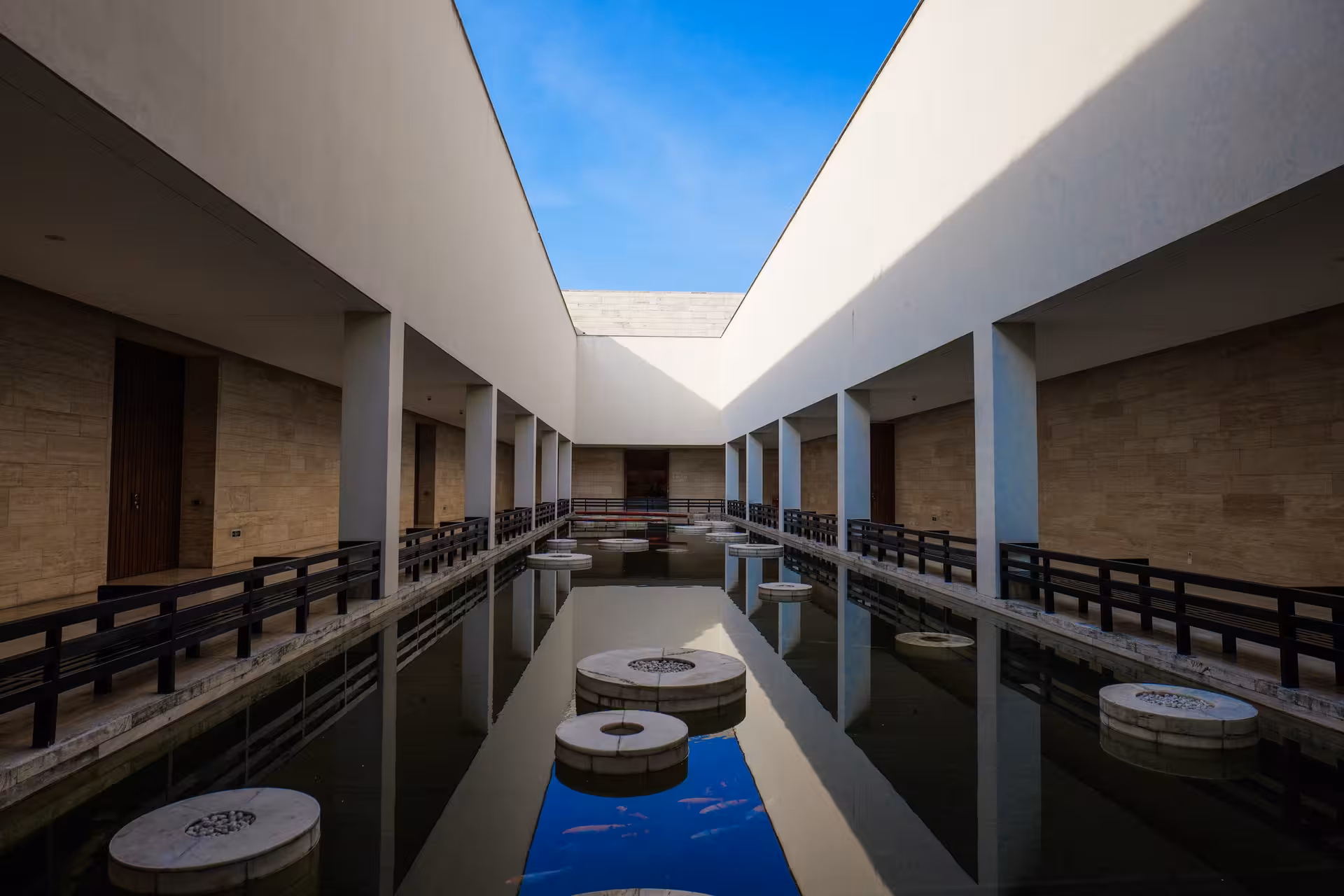 Modern architectural design in Hangzhou with a reflective water feature, blending contemporary aesthetics and tranquility.