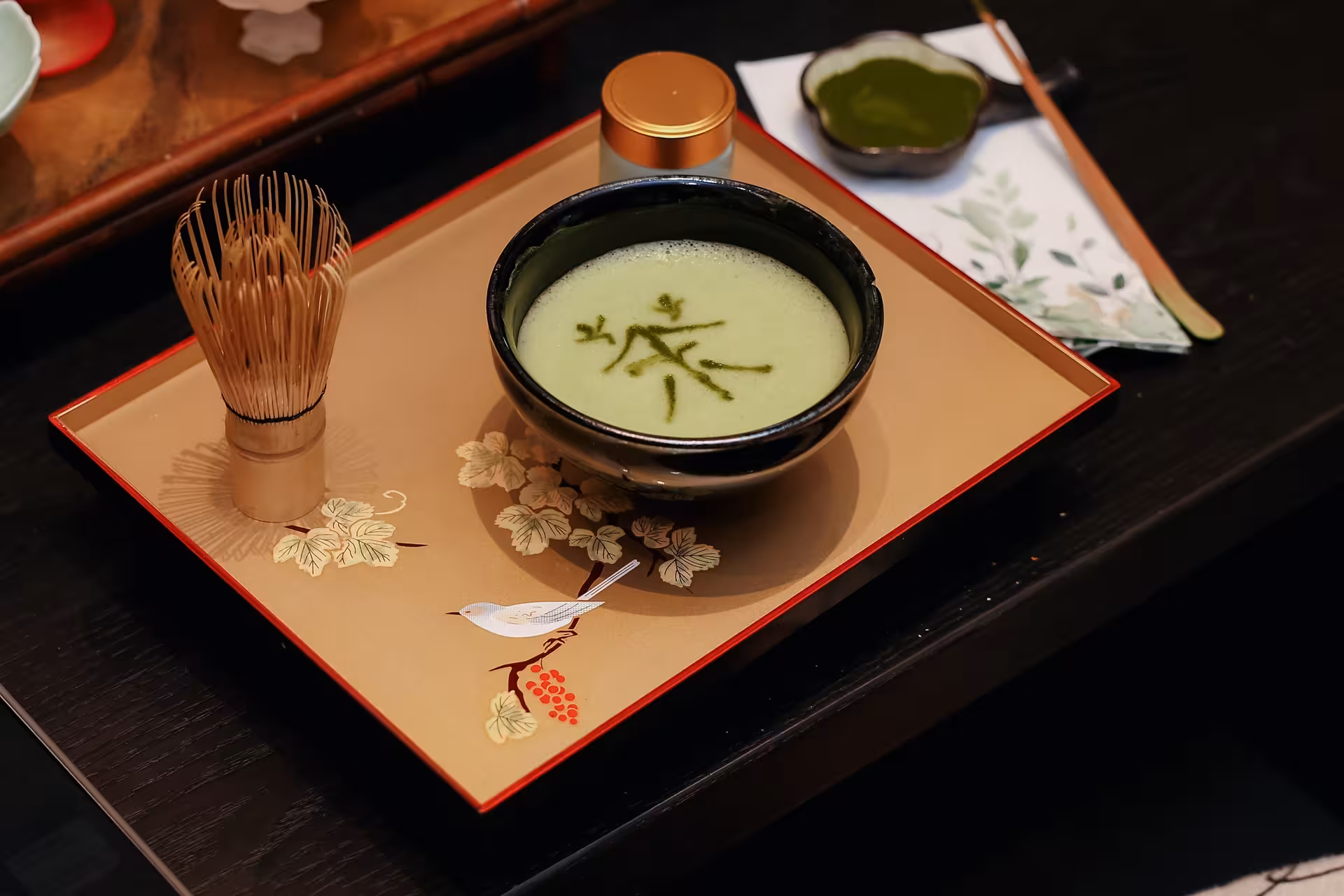 Traditional tea ceremony setup with matcha bowl on decorative tray, highlighting Hangzhou's cultural tea heritage.
