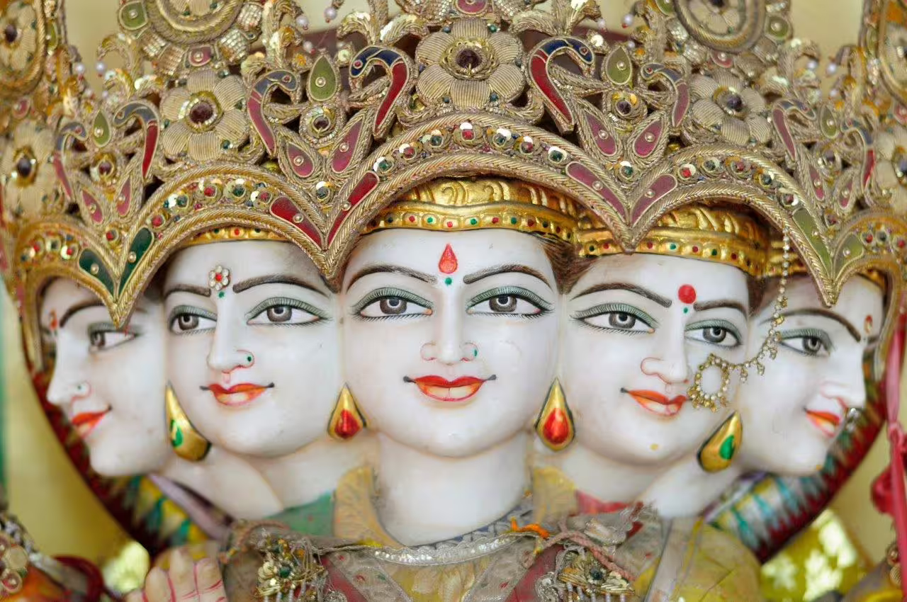 Intricate sculpture of a multi-faced deity in Haridwar, showcasing traditional Indian artistry and craftsmanship.