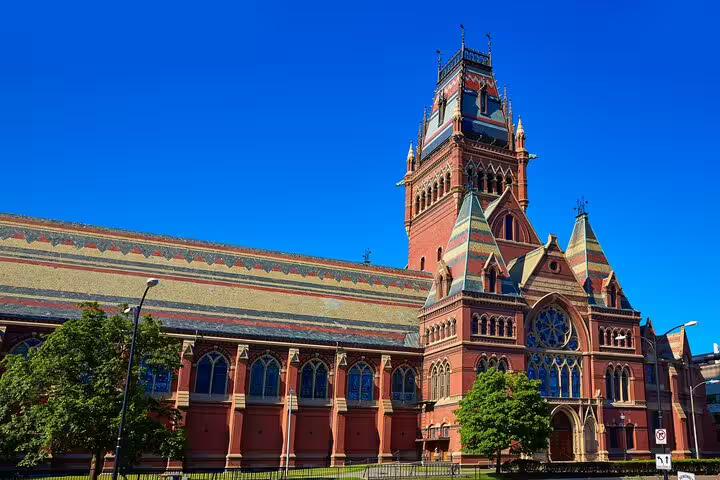 Memorial Hall at Harvard University, red brick Gothic Revival building with ornate tower under blue sky