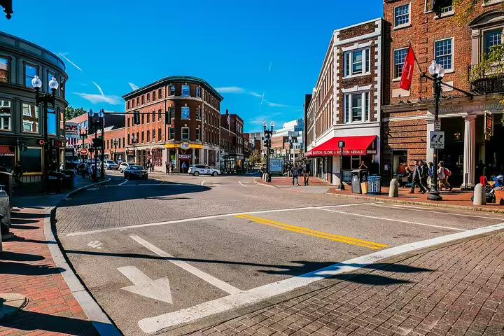 Historic brick buildings and street intersection near Harvard Square, Cambridge, on a sunny day