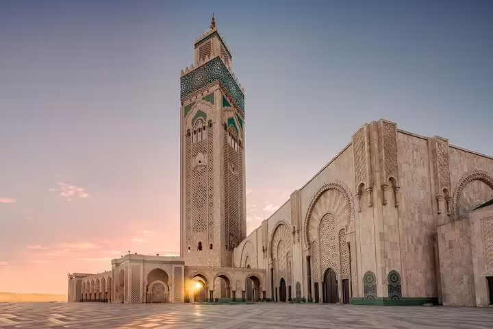 Hassan II Mosque in Casablanca at dusk, iconic stop on Morocco 12 days tour from Casablanca with grand minaret