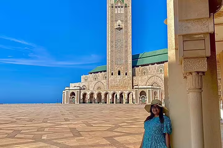 Traveler at Hassan II Mosque courtyard in Casablanca, start of Morocco 11-day tour via Sahara Desert and Merzouga