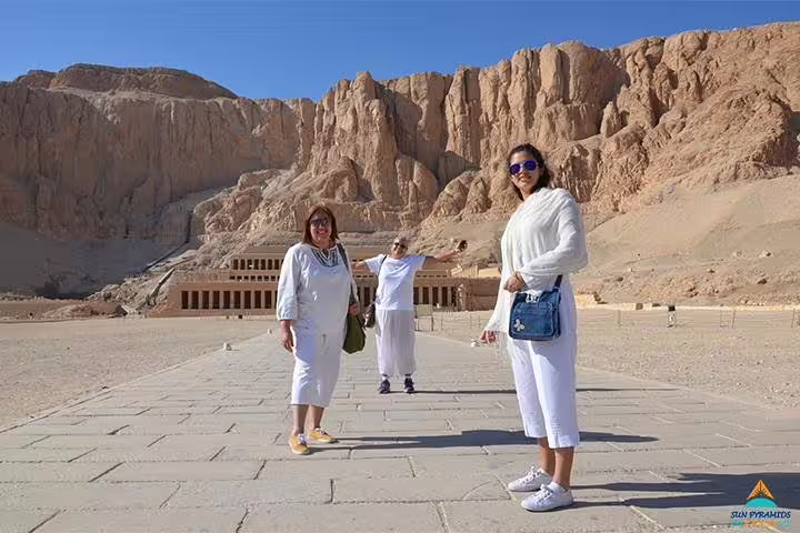 Tourists at Hatshepsut Temple with Theban cliffs, West Bank Luxor, on a 3-day Luxor city break
