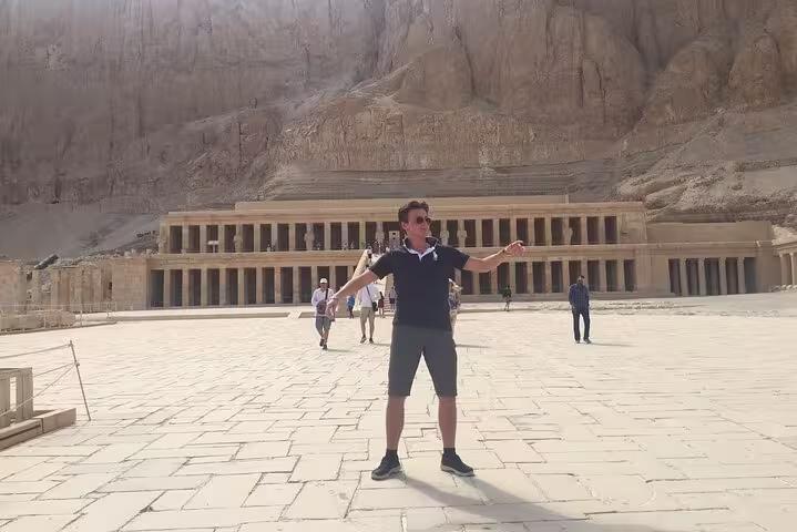 Visitor posing in front of Hatshepsut Temple in Luxor on a private Hurghada to Luxor day trip excursion