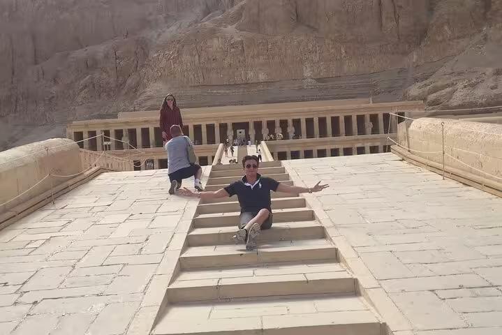 Traveler on steps at Hatshepsut Temple, Luxor West Bank, on private day tour from Hurghada with guide