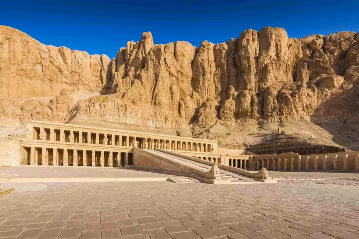 Majestic view of Hatshepsut Temple nestled against rugged cliffs in Luxor, ideal for cultural exploration tours.