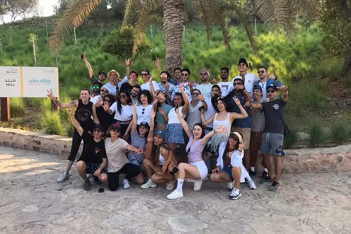 Happy tour group photo at Hatta Hill Park on a private full-day Hatta trip from Dubai for 1–6 pax