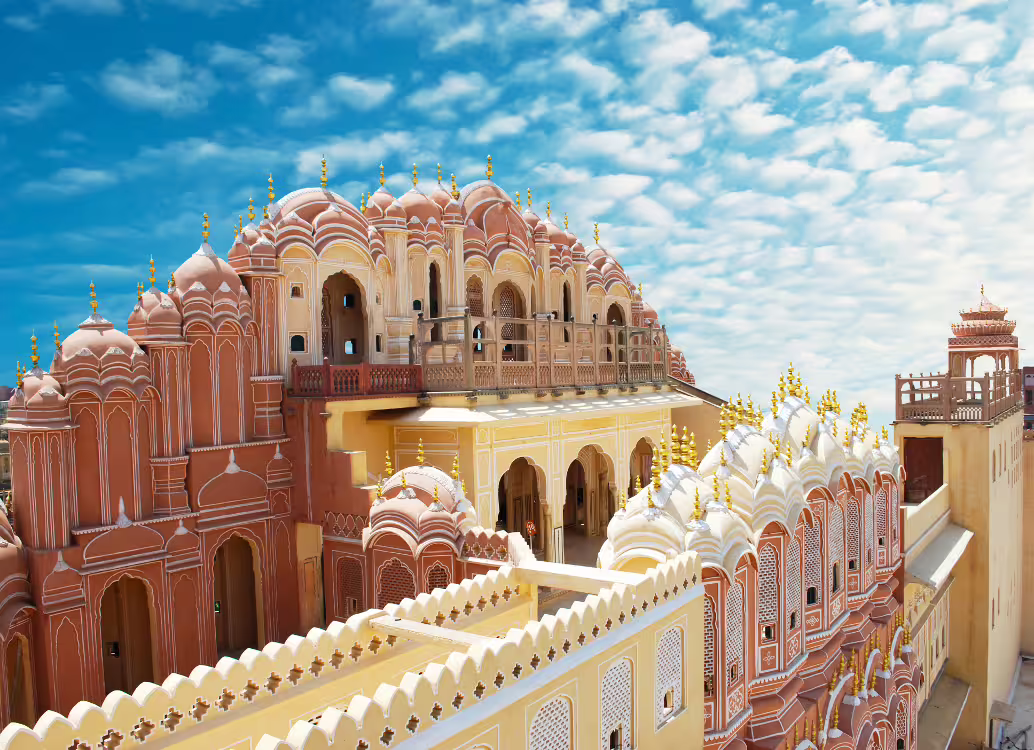 Explore the iconic Hawa Mahal's intricate architecture under a vibrant sky on the Golden Triangle 6-day tour.