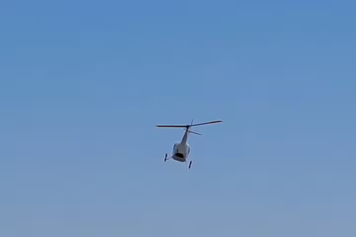 Helicopter flying over Cape Town, offering panoramic views on the Atlantico tour from Atlantic Coast to Hout Bay.