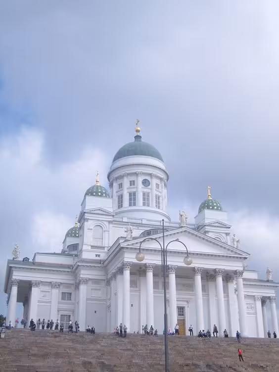 Majestic view of Helsinki Cathedral with grand steps under a clear blue sky, a highlight of Finnish architecture tours.