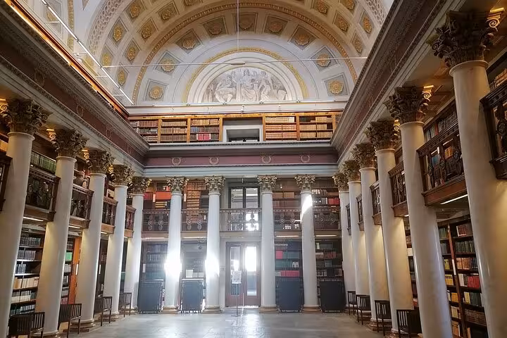 Discover Helsinki's majestic library with grand columns and ornate architecture on a walking tour with a sociologist.