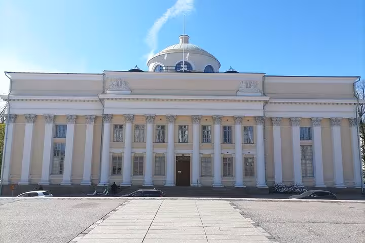 Exterior view of a neoclassical building with a domed roof, featured on a Helsinki sociologist-led walking tour.