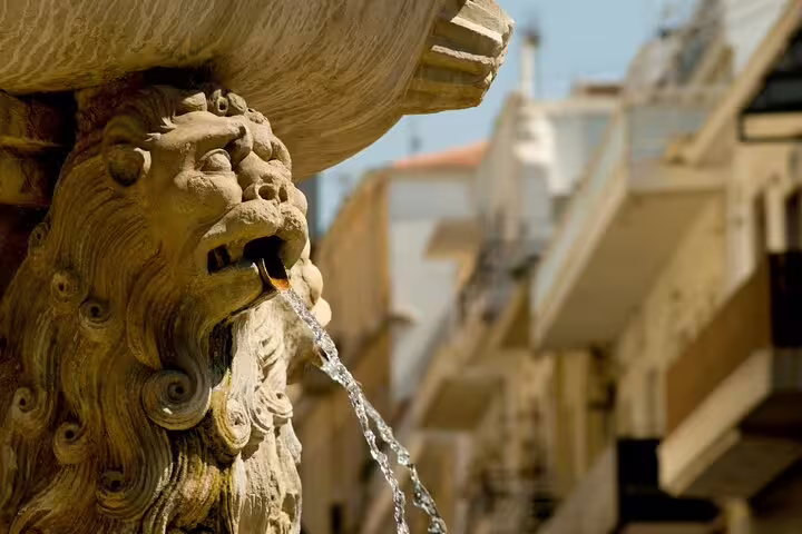 Close-up of a lion's head fountain in Heraklion, showcasing iconic Cretan architecture and craftsmanship.