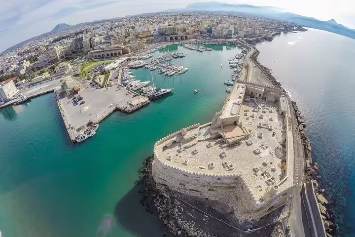 Aerial view of Heraklion's Venetian harbor and ancient fortress, ideal for exploring Knossos Palace and the Archaeological Museum.