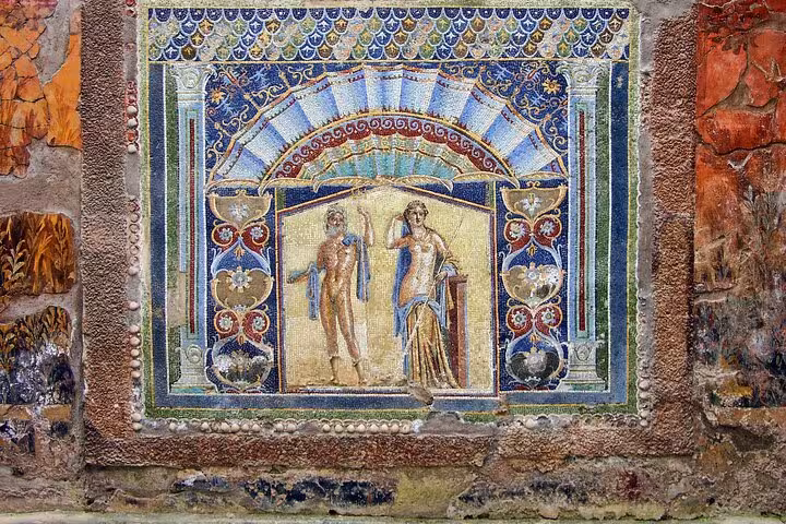 Admire intricate ancient mosaics at Herculaneum, showcasing vibrant colors and detailed artwork on your skip-the-line tour.