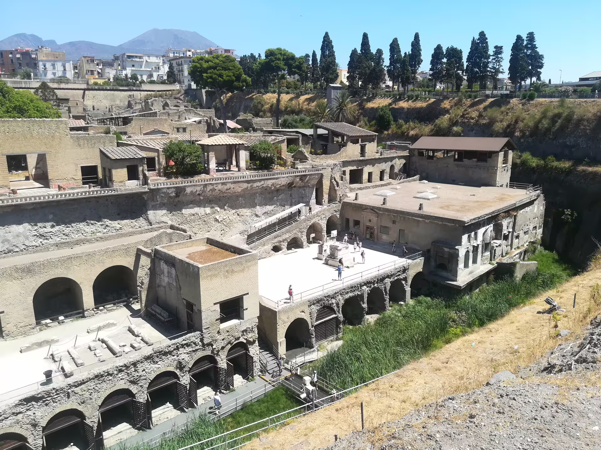 Herculaneum archaeological site near Naples with ancient terraces and Vesuvius views on low cost day tour