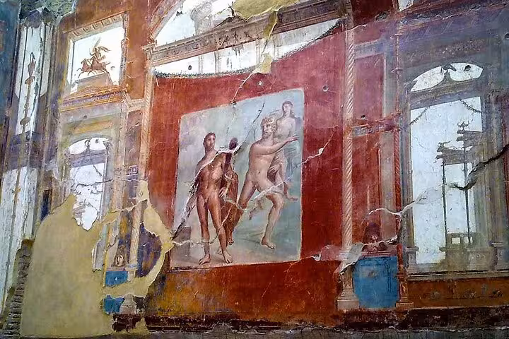 Explore ancient frescoes in Herculaneum's ruins on a guided tour with lunch and tickets included.