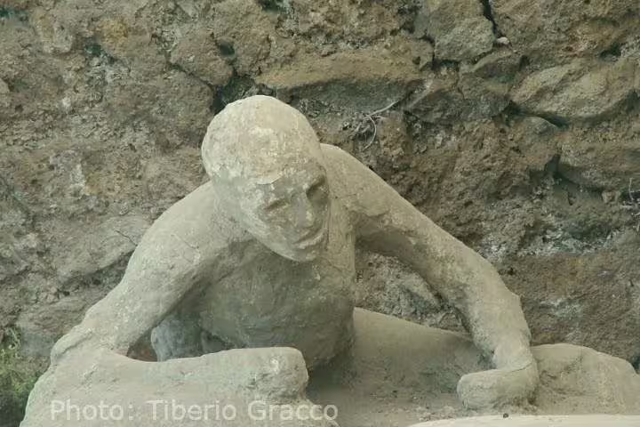 Plaster cast of a victim at Herculaneum ruins, Vesuvius tragedy, budget Naples day tour