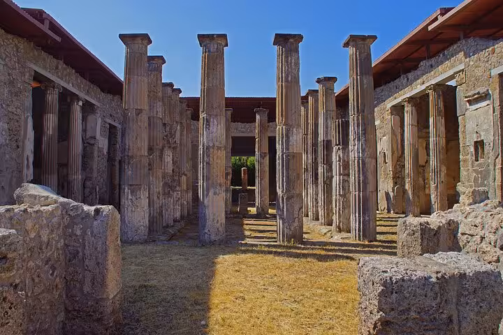 Well-preserved columns at Herculaneum, showcasing Roman architecture on a guided full-day tour with entrance included.